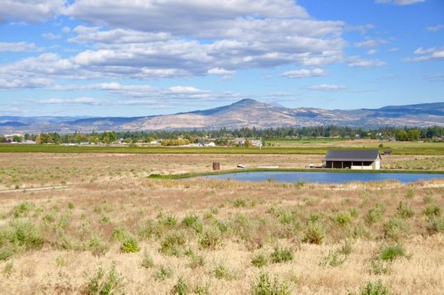 116 irrigated acres of prime farmland just outside Jacksonville with potential home site. Outstanding location with views of neighboring vineyards and Table Rock, very fertile soil & MID irrigation for the entire property. City water in place across the entire property. Two irrigation ponds equalling 5 million gallons with 3 pumping stations, (one newly installed station with filtration system specifically for drip irrigation). 2,400 sq ft equipment shop and access roads throughout the property.