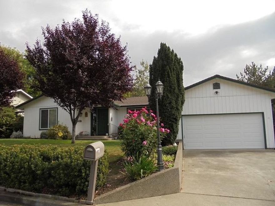 Paradise in town. This Shangri-La property is situated in a very desirable NE neighborhood of Grants Pass The lovely updated home fits on this large lot that features also an enormous back yard with ample room and mature landscaping plus a pool makes the setting feel like it is in the country. This home has had extensive updates and feels like a late model home with hardwood floors, Corian counters, and custom appliances plus vinyl windows and new roof just a few years ago. The three bedrooms are all large and both the living and family rooms are expansive. This is a wonderful home that is truly a great value in today's market and it won't last long.