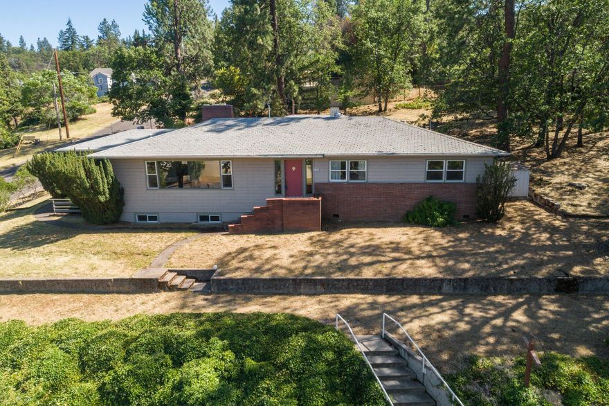 ATTENTION INVESTORS! Welcome to Ashland, where an amazing opportunity awaits! Located across the street from SOU and after more than 50 years of serving the community, the Newman Center is ready for a new owner. Resting on .60 of an acre, this spacious property allows for so many options. The lot can be split or left as is, allowing you to enjoy one of the largest lots in the neighborhood. This 2282 sq/ft single story home has SO much potential and the finished basement provides an additional 1412 sq/ft of living space, 2 additional rooms, a full bathroom, small kitchenette, fireplace and its own private entrances. There is room for RV parking and the property is perfect for additional ADU's. All this, plus magnificent mountain views while just minutes from downtown Ashland, this property must be seen to be truly appreciated. Don't miss out, schedule your tour today!  Home is being Sold 'as-is'' and needs some love and modern touches to help make it shine!