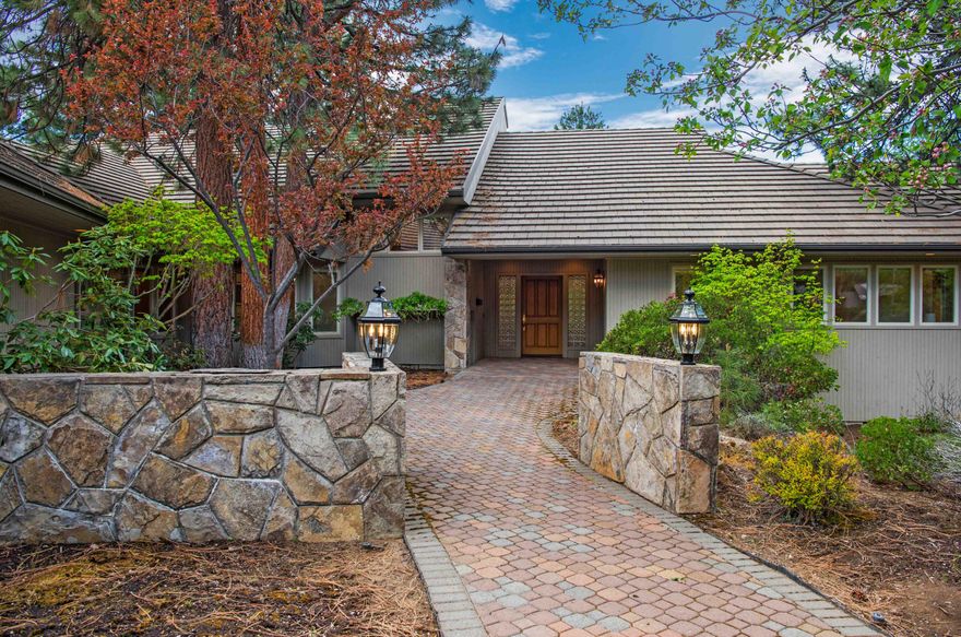 Tucked within the gated Sunset View community in SE Bend, this freshly updated home sits on an impressive 2.38 acres, nestled among stately homes and the gently rolling Lost Tracks golf course. This growing area of town offers residents amenities and infrastructure, making it increasingly popular for those seeking a balance of community, convenience, and access to Bend's outdoor lifestyle. Here, an expertly designed layout offers a lifestyle reminiscent of a bygone era - complete with formal dining, ensuite guest rooms, flex spaces, and a truly luxurious primary wing - yet it boasts fresh finishes, open spaces, and a generous scale that endow this home with a grand allure. Oriented toward the west and surrounded by lush, mature landscaping, the home features floor-to-ceiling windows, ensuring that the surrounding views are a constant companion. Offering a lifestyle that is hard to replicate, this home warrants a private tour to be fully appreciated.