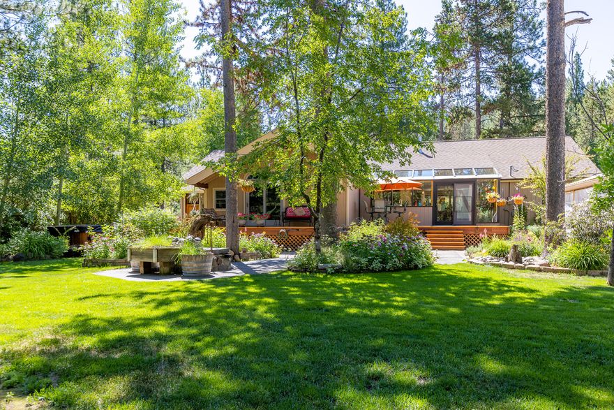 This NW style home offers direct access to the wonders of the Deschutes National Forest and is only 15 minutes from Downtown Bend. Featuring a bright, open floor plan with a well equipped kitchen, dining area, cheery sunroom, and easy access to the back deck. The primary suite boasts vaulted ceilings, wood beams, fireplace, walk in closet, and dual sinks. A second ensuite bedroom and a third bedroom with garden views provide flexible living options. Enjoy a spacious bonus room and a 3/4 finished basement. The fully fenced backyard includes a lush garden, sprinkler system, greenhouse, and two large insulated storage sheds. A four car garage provides plenty of space for vehicles, gear, and toys. Experience the perfect blend of nature and modern comfort!