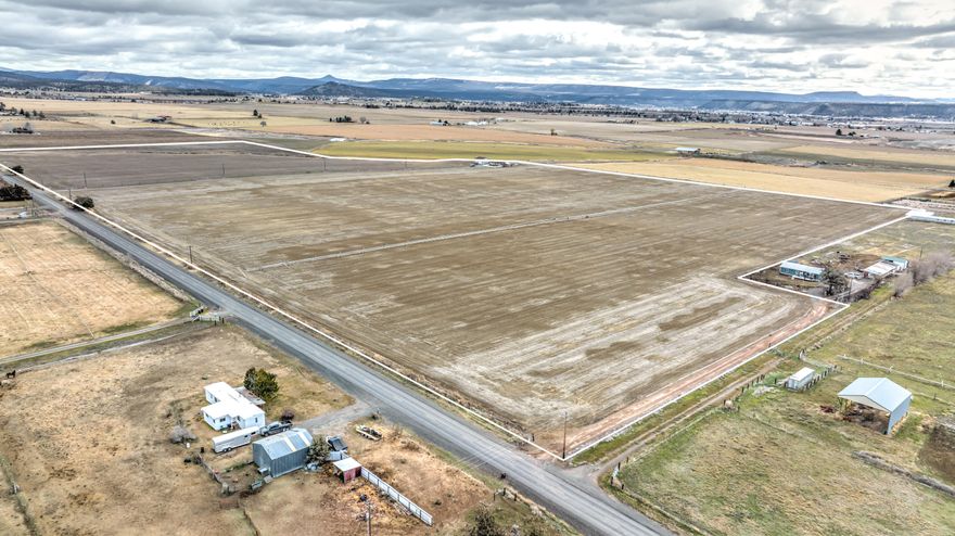 Have you been looking for a nice quiet piece of farm ground? Take a look at Grimes farm. This 77.98 acre parcel features a custom built, newer 2,040 square foot manufactured home and a 1520 square foot shop that sits at the end of the long private driveway that runs through the property. The Grimes Farm features 77.8 acres of O.I.D. water rights. The irrigation system consists of three wheel lines, a pivot (that
needs to be installed, but is at the location) and hand lines. Currently there is a stand of alfalfa planted, and a stand of teff hay, that needs to be replanted every year. Or, it's ready for a new crop for the new owner's for the 2022 farming season. This is excellent deep farm ground suitable for high yielding hay and grain crops, permanent pasture or high valued row crops. Small, high quality farms with great locations like this one are really hard to come by.