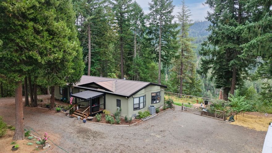 Situated on 6.28 tree-lined acres with stunning views of the Cascade Gorge, this beautifully remodeled 3-bed, 2-bath home with 1,647-sq. ft. offers peace, privacy, and endless opportunity. Recent upgrades include a new heat pump, fresh paint inside and out, updated kitchen and bathrooms, new decking, and more. The property is wonderfully maintained with a park-like setting, garden area, greenhouse, water feature, and irrigation rights. An impressive red barn, animal pens, RV parking, and a shop with concrete floors and a finished retail space up front (currently used as a bridal boutique with road frontage) add to the versatility. Additional features include a metal roof, backup generator for the well, and a strong-producing well (per seller). Perfect for hobby farming, home business, or simply enjoying the serene setting, this property truly has it all!