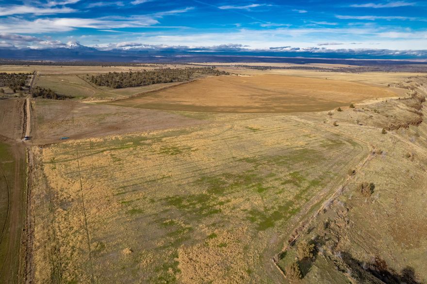 Excellent Opportunity to own this productive 805.92± acre farm located just 2.4 miles west of Madras.  Just a short drive to Madras, or Redmond for farm supplies, shopping, and dinning.  Enjoy the sunsets over the Cascade Mountains, as you operate your farm.  The farm's rich, loamy soils coupled with 232.9± acres of irrigation water rights (176± acres Deschutes River; 56.9± acres Crooked River) delivered by the North Unit Irrigation District can produce all crops common to the area. Irrigation distribution is aided predominately by two center-pivot systems, with some wheel line and handline areas.  Don't miss this opportunity to get started in or expand your farming operation, all while enjoying Central Oregon's Cascade Mountain views!