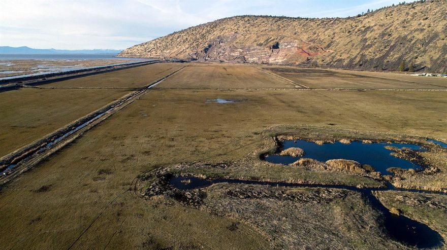 Great Ranch/Farm located just east of Klamath Lake. 400 acres, perimeter fenced and cross fenced, Flood irrigated, can run 200 pair during the summer months. along with Grain silo, corrals, and a storage shed. Water fowl are in abundance here. This could also be a great location for a duck hunters lodge, Easy to show.
