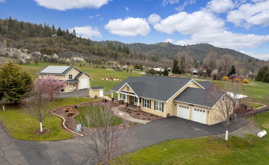 Beautiful and meticulously maintained home located on 7+ acres in the desirable Griffin Creek area. Custom built craftsman style, single story home that offers 3 bedrooms, 2 full bathrooms. and an amazing library/study. Open and inviting floor plan with vaulted ceilings and large picture windows to take in the wonderful views. Huge Cumaru wood deck with outdoor kitchen, covered for entertaining all year round. Beautiful landscaping and water feature. Do not miss the 1450+ sqft shop/rv garage with full bath and addition sqft in the finished bedroom above! And to top it off, the home features an owned whole home solar system to bring your power bill to almost net zero!