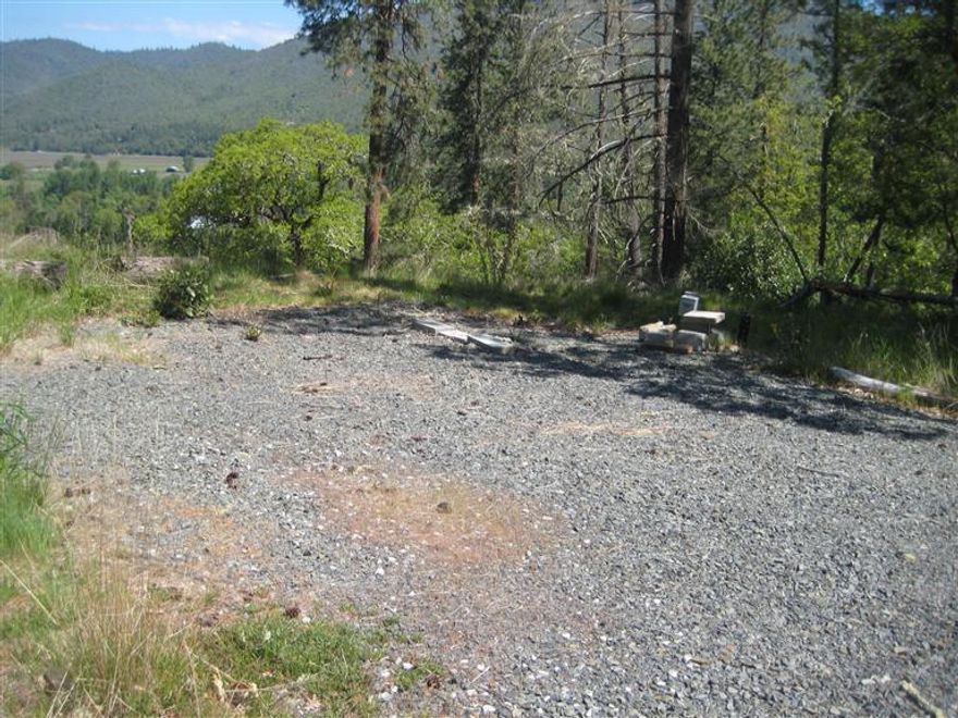14+ Acres VIEW property in the highly desirable Applegate Valley, OR. 10 acres approximate pasture with homesite in the trees at the top of the property overlooking other ranches and the Applegate River! Deeded water front but Hwy 238 intersects it. The tree lined drive (about 1/2 mile off the hwy and partially paved) is part of this parcel. 25x45 shop building with concrete floor, well is in 12 gpm when drilled, septic installed as well. 75x32' area for the home has been cut and filled. This peaceful setting abuts public lands with miles of trails! Wonderful area of gentlepeople's farms; llamas, sheep, goats and more. It's the Oregon Dream! State says water rights are available from the Applegate River but Newberryman Ditch Association will have final say.