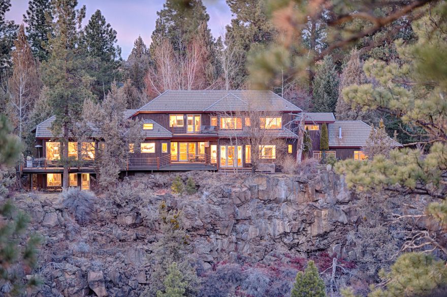 Two residences, Main house 4058 sq. ft. with 3 bedrooms and 2.5 bathrooms plus Guest House 955 Sq. ft.  with 3 bedrooms and 1 bathroom. Luxury Waterfront Estate with 265 feet of Deschutes River Frontage.  Located at the end of the road overlooking the Archie Briggs green space and adjacent to Riley Ranch Reserve Park.   Two separate three car garages and RV Parking. Built in line with the Summer Solstice; Giving this home passive solar summer relief and gain in winter. 
The main residence benefits from post and beam construction with soaring 18' ceilings and interior waterfall opening to bottom level family room.  Gourmet kitchen with Wolf Appliances and waterfall edge granite countertops.  RADIANT HEATED FLOORS! throughout the main house and three fireplaces.  Jacuzzi Tub and Hot Tub with river canyon views.  Garden setting with streams and ponds.  Swalley irrigation rights and separate fresh water well with rights for each house.  The Owner is an Oregon Licensed Real Estate Broker.