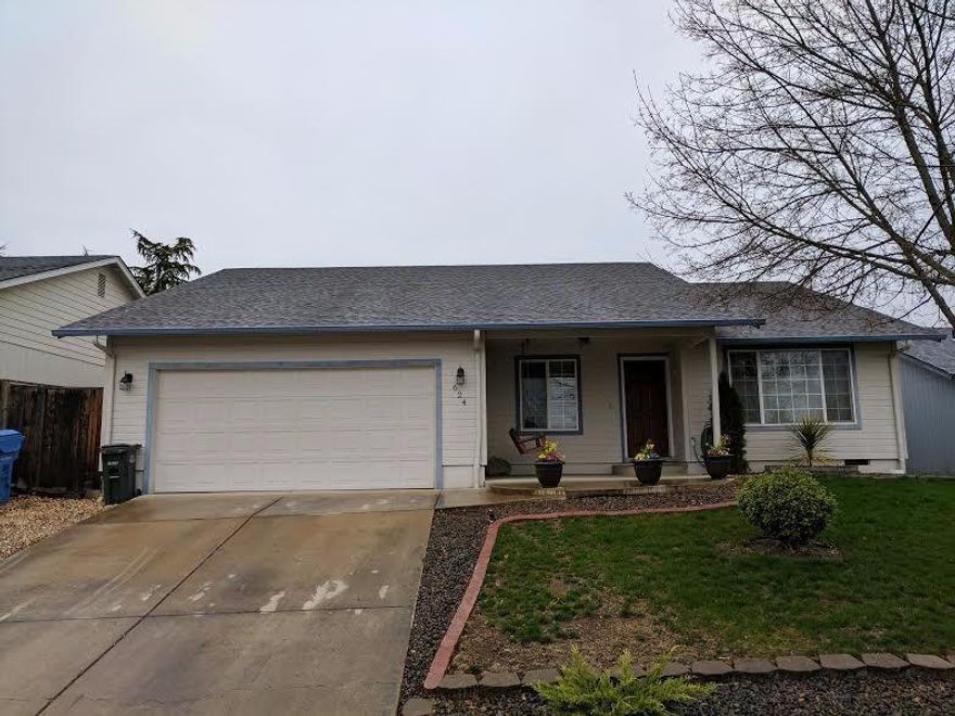 Fabulous home with 3 bedrooms and 2 bathrooms in Eagle Point. There is 1344 sq. ft of living space with a Pergo entry way and vaulted ceilings in living room, kitchen and master bedroom. Large kitchen featuring tile floors and lots of cabinets/counter space. Great size rooms with a nice master with walk in closets and recently remodeled bathroom. Easy maintenance yard with automatic inground sprinklers in the front and back. Large backyard with covered patio. Great two car finished garage with tons of storage space and attic accessible ladder. Driveway is extra wide and can accommodate an extra vehicle or boat. Enjoy views of surrounding mountains in a home that sits above the street.