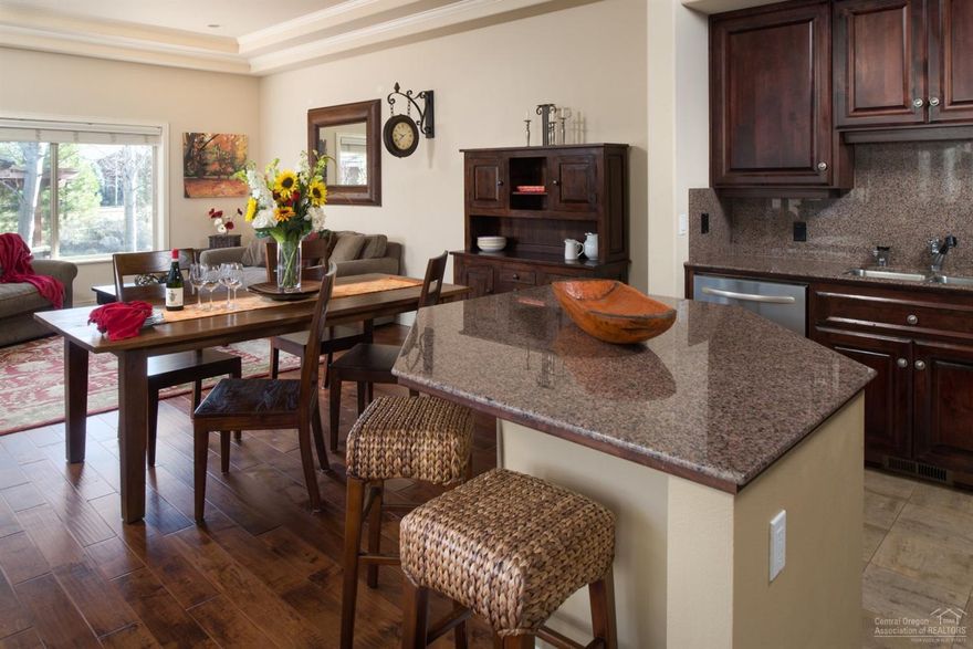 Rare find! Townhome in the Gated Courtyards Golf community of Broken Top. Enjoy the solitude and security of this exclusive neighborhood and the amenities offered here. This townhome offers a spacious patio & hot tub area off the great room. Open kitchen with granite countertops, stainless steel appliances & eating bar. Newer distressed hard wood floors. Jr. suite on main level w/ master suite upstairs & private balcony. Includes detached garage & storage room. Vacation rentals allowed.