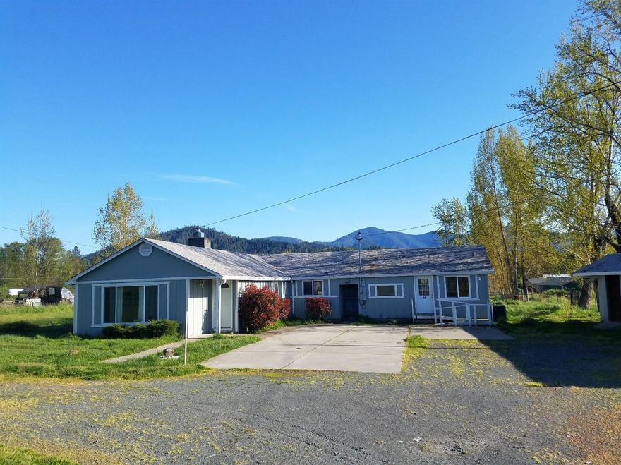 Great country property, close to town with 1.22 irrigated acres in SW Grants Pass. Home features 3 bedrooms and 3 bathrooms; indoor laundry room; and garage is converted to additional living space. Large kitchen with an island and lots of storage! Kitchen and dining area also has a patio doors that opens to one of the 2 covered patios (with composite decking and fan) to enjoy the mountain views! Family room has wood burning insert in the fireplace, built in cabinets and new carpet. Master bedroom has a window seat, walk in closet, nice master bath and a patio door to the deck. Outdoors you will find a fenced yard and pasture area; a storage/shop building; an artesian well and a circle driveway with 2 gated entrances. So much to offer in this property! Come tour today!