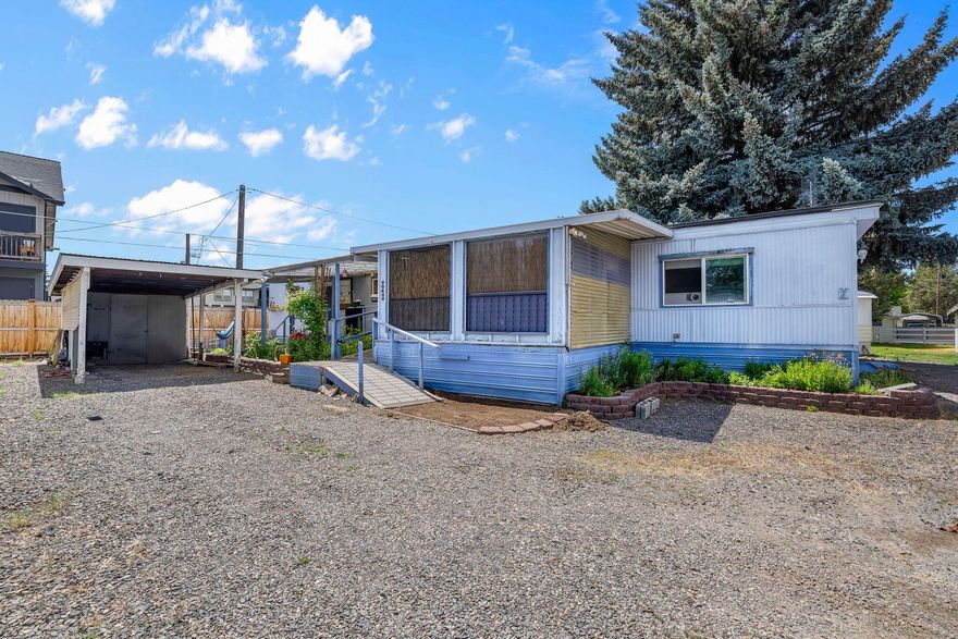 Located in a 55+ well maintained community close to downtown Redmond shopping, restaurants, healthcare & recreation. Well sized living area boasts laminate flooring, an abundance of natural light & windows w/separate dining & kitchen areas. Kitchen has plenty of cabinetry storage & counter space for prep, with all appliances included. Small dining area located adjacent to the kitchen. Spacious primary & secondary bedroom with access to full bath featuring step in shower. Washer/Dryer area w/shelving. Outside you'll find a well sized screened in porch, garden areas, sheds, accessible ramp access to home, & a covered carport parking space. Don't miss this one, it won't last! Current land lease of $618/month