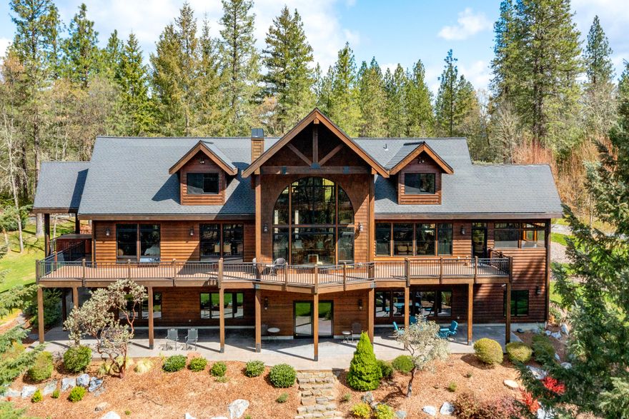 Just minutes to access the World Famous ''Wild & Scenic'' Rogue River. This exceptional custom-built, 6,376' sqft luxury lodge style home provides privacy, expansive open floor plan, smart home technology, peace & security. Incredible location, 9.99 park-like acres in the heart of the Rogue Valley. Only minutes to world class adventure, cultural arts, fine dining, & award-winning wineries. Energy efficient geothermal heating/cooling continues throughout the vaulted great room, gourmet kitchen, main level ensuite master bedroom, home office, & lower-level media/entertainment area. Designed to bring nature inside, this home offers views from every room. Includes new six burner Wolf rangetop, newly added road/driveway access improvements, garden area, & property has been completely fenced. Outdoor-living is featured by a BBQ room, expansive wrap-around deck, spa, shuffleboard court, picnic area, landscape lighting, 3 car garage +480' shop. 2 tax lots zoned RR-5, potential two family setup.