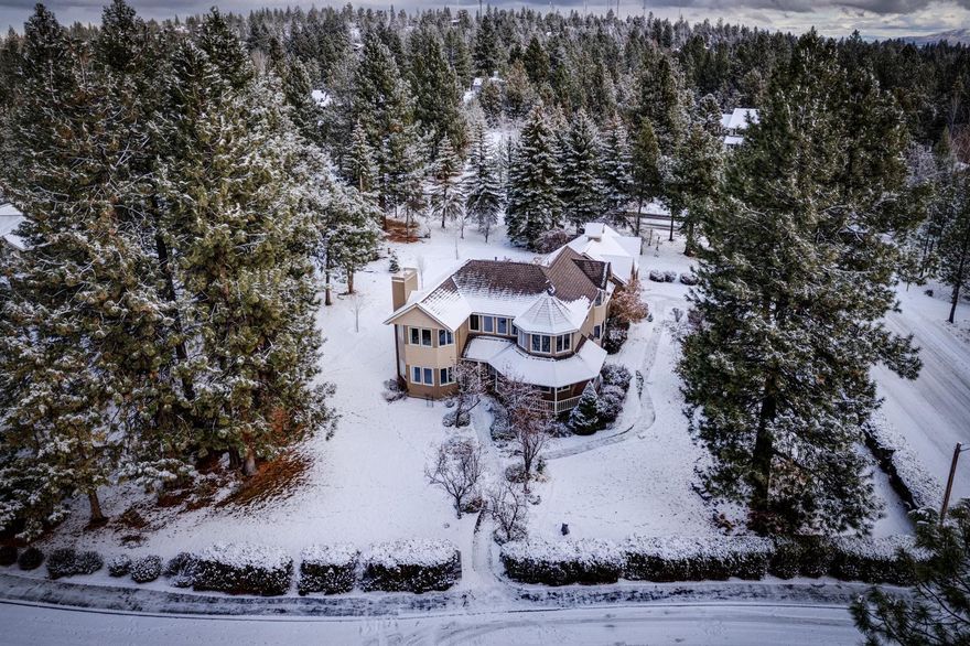 This home exudes story book charm with its gingerbread trim and Victorian style architecture and graces a prominent spot at the top of Awbrey Butte. The traditional floor plan is comfortably laid out and provides ample separation for in-home office yet open between the kitchen and family room. This home is a solid build with warm woodwork, bay windows, woodstove fireplace, is bright & light with many more custom features. It's spacious flat lot with beautiful flowering and evergreen trees has plenty of open space for game and sporting activities! A flat paver driveway with large 3 car garage is super convenient. This is a unique and charming home ready for your custom updating.