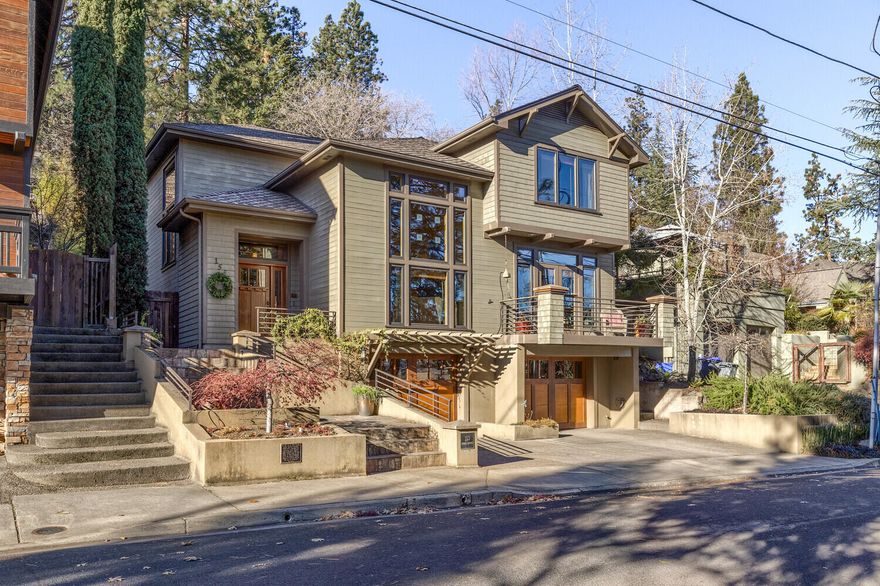 Beautiful timeless craftsman located in the heart of Ashland - just above downtown, restaurants and OSF.  An elegant slate staircase leads you to the home's impressive entry. The main level features beautiful madrone wood floors, 18' ceilings with large windows capturing tons of natural light and beautifully frame the surrounding trees. The living room and family room are separated by a warm double-sided gas fireplace. The generously sized kitchen boasts a large center island, granite counters, beautiful maple & mahogany cabinetry with plenty of storage. Upstairs you'll find the two spare bedrooms, one with access to the backyard deck, separated by a guest bathroom. The primary suite has great views, dual vanities in the bathroom and a generous closet. The 600 SF studio in the backyard can also be accessed from Hillcrest Street and has even more impressive views, a full bathroom and an open floor plan. The ample two car garage has tons of storage and features a wine cellar!