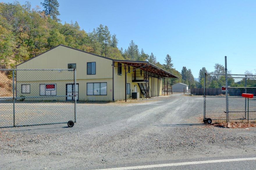 Excellent opportunity on rare industrial property in Josephine County. Currently set up with a large industrial building, mini storage, and home. 6.65 acres in total, this property is ideal for a multitude of commercial/industrial uses. Large approximate 5000 square foot shop with large gravel parking lot that could accommodate semi-truck turn around. Mezzanine could be additional management quarters, offices or space as needed. Shop also has 15' covered awning the length of the building for additional covered workspace. The property is security fenced at the street. Additional 12x30 metal storage building, barn, and implement shed. 20 units total in mini-storage configured in approximately 8x10 units with plenty of space for expansion. Manufactured home is 1485 square foot, 2 bed 2 bath. Excellent outdoor storage potential on this property as well. Don't wait, call today!