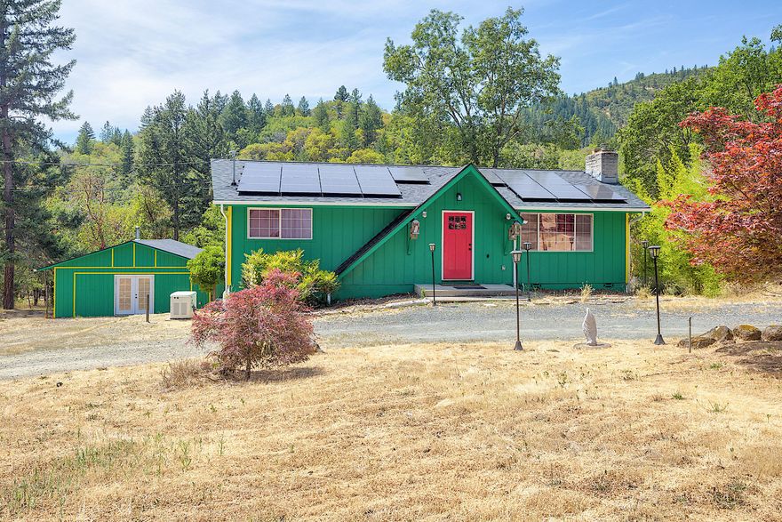 Nestled in the scenic Murphy area, this wonderful home is just minutes from the Applegate River and Southern Oregon's renowned wine country. This 1,416 sq. ft. home was completely remodeled just two years ago, offering a fresh and modern feel throughout. The open-concept living area features a cozy rock fireplace with a brand-new, never-used woodstove. The light-filled kitchen boasts new appliances and flows seamlessly into the spacious living and dining areas. On the main level, the primary bedroom includes an oversized closet, while downstairs you'll find a second en suite with private backyard access — ideal for guest quarters or multi-generational living. Outside there is a fully fenced backyard with a brand-new shed for extra storage and a generator. There's also a finished workshop, complete with a woodstove, making it an excellent space for hobbies or a home office. Set on a level acre, this property offers room to grow or simply enjoy the tranquility of country living.