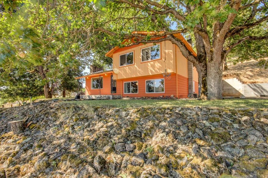 Wonderful property with views of the Table Rocks and surrounding foothills. Built in 1974, 1738 square feet, the kitchen has been upgraded with granite counters and wood floors. There are 3 bedrooms, 2 full bathrooms, a family room with a new certified wood stove, a fireplace, and a large utility room/pantry. New thermal windows throughout, the guest room has a queen size Murphy bed which stays with the house. The brick patio is beautiful and roomy with accent lighting. The property sits on a beautiful 5.3 acre parcel made up of two tax lots. There is a large shop (approx 900 square feet plus a mezzanine) with an oversized 13 foot rolling door. 16' ceiling, 220 and 110 electrical, metal roof with skylights. There is a 2000 gallon holding tank put in in 2014, the well is 60'deep. 8 gpm per seller.