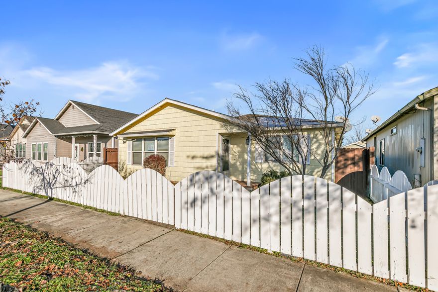 Welcome home to this charming single-level 3-bedroom, 2-bath residence with classic curb appeal and a white picket fence. Priced at just $350,000, this home offers over 1,400* square feet of comfortable living space in a convenient Medford location near Rogue X, shopping, dining, and more. Inside, you'll find an open floor plan with vaulted ceilings, laminate flooring, and abundant natural light. The primary suite features an ensuite bath with dual vanities, a walk-in shower, and sliding door access to the patio and low-maintenance backyard. A wonderful opportunity to own a great home at an exceptional price. 
*Per FHA Appraiser 1434 sq ft, per Assessor 1401 sq ft.