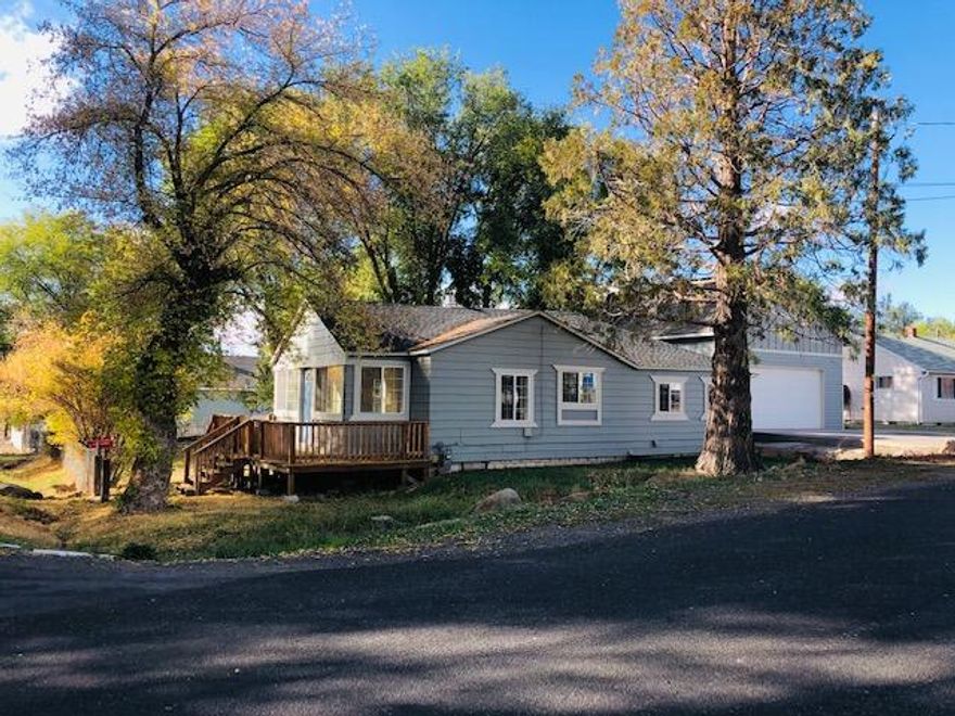 Completely updated 3bed/1bath on a large, fenced, corner lot.  Tastefully updated Kitchen, recessed lights, counter tops, cabinets, tile backsplash, new fixtures, new appliances including gas stove. New flooring throughout the house, new vinyl windows, and updated bathroom.  The new gas fireplace in the living room is perfect for the upcoming winter nights.  A two-story, 2 car garage/shop with heated concrete floor, and a half bath, is ready for your finishing touches.  The paved driveway is prepped for heat as well.  Brand new roof in 2021.  This home is ready to move into!