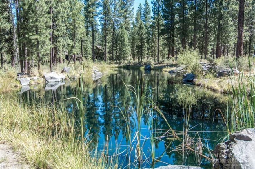 Beautiful flat Caldera Springs home site with loads of character! Majestic Ponderosa Pines dot the lot and there's even a peek-a-boo view towards the pond! This is an ideal location in an area of very nice homes!