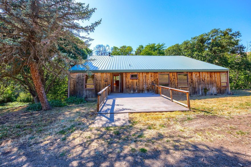 .Truly unique 60+ EFU acre parcel with end of the road privacy, Mt. Ashland and valley views, and wooded creek running across the property. In addition to the serene setting and varied topography, there are 11 acres of irrigation rights across two pastures, with possibilities for vineyards, orchards, animal pasture or other agricultural endeavors. First time on the market since the 1970's, the 2744 sq. ft. dwelling is a project house with significant deferred maintenance. This could be a very special rural retreat in a lovely pastoral setting close to downtown Ashland and its many amenities. Value is primarily in the land, this is an As-is sale.