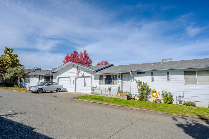 Charming Duplex Near Downtown Grants Pass! Excellent investment opportunity just minutes from the heart of town. This well-maintained duplex offers strong rental history, with both tenants having long-term occupancy and reliable monthly income. Each side features 3 bedrooms, 2 bathrooms, and its own garage—ideal for stable, long-term tenants. Both units have newer roofs and HVAC systems, providing peace of mind for years to come. Interiors could benefit from cosmetic updates, offering room for future value-add improvements. Conveniently located near shopping, dining, schools, and all city amenities, this property delivers consistent performance in a high-demand rental area. With separate utilities, ample parking, and easy-care grounds, this is a turnkey investment that combines dependable cash flow with strong upside potential in the thriving Grants Pass market.