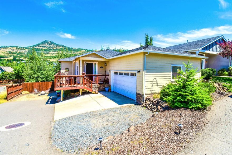 Spacious 2 level home with ample room inside and out. Located in desirable east Medford. As you enter you immediately notice the travertine floors and updated fixtures. The large open kitchen features a gas range and stainless appliances with pantry and laundry space tucked away near by. Large dining space is complemented by the cozy family room surrounded by many windows to take in views of the valley and roxy anne. Master and haldf bath on main level, and 2 additional rooms, full bath and bonus room on lower level. Home features more storage than you could fill, multiple outdoor living spaces, large finished garage and rv/boat parking. Come see this one today!