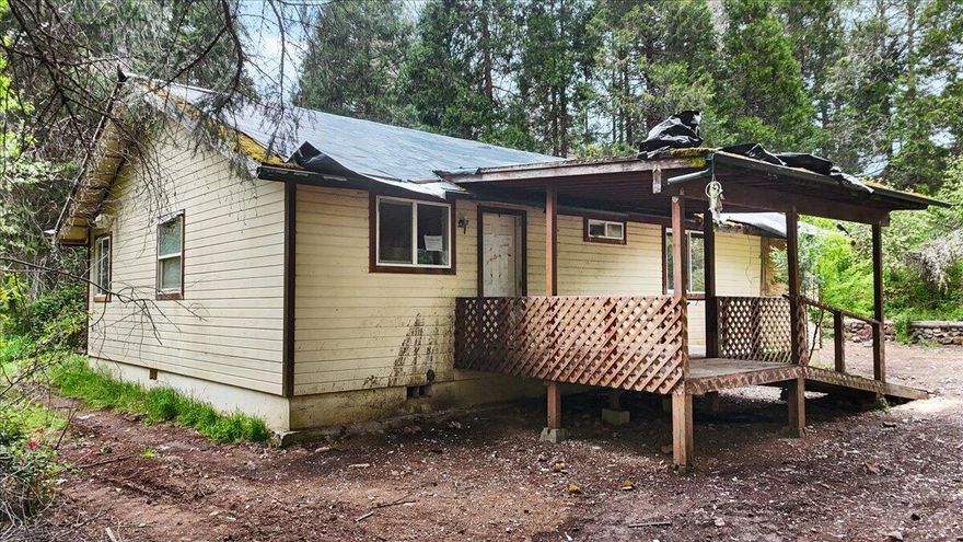 Potential to be part of this heavenly property's amazing come back story. Sitting in the confluence of Elk Creek and Flat Creek you are surrounded by nature and constantly serenaded by the sound of flowing water with creek frontage on two sides. Recreation is not close by; you are among it. 3BR/2BA 1408SF main house built in 1997. An additional campground-style deluxe log cabin will make you an instant hit with friends & family and memory packed weekends. Possibilities abound for weddings, short terms rentals, Bed & breakfast, corporate / artist retreat, hunting/fishing lodge, or extended households, or your very own vacation get-away. Bordered by govt land and timberlands. Buyer to do all due diligence for uses. See Instructions.