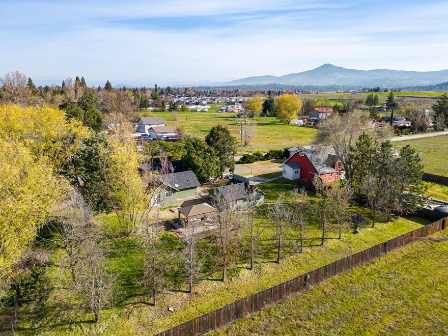 Single Level & Open Floor plan! This 1732 sq.ft., ranch style home features comfortable living and new flooring recently installed in the kitchen, dining and family room areas. Fenced 1+ acre EFU lot offers a wonderful lawned yard with mature trees including fruit trees. Large gazebo for outdoor entertainment. The 480 sq.ft. ADU building has newer siding and roof and is ready for interior repairs. Three garage/storage units and a 1474 sq.ft. carport for all your toys and projects. 2 story barn and a fenced RV storage lot. Gorgeous views of the surrounding mountains! So many possibilities with this home and parcel. A Mush See! Seller is related to licensed real estate agent.