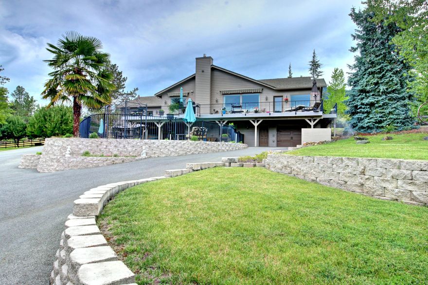 Welcome to Paradise! Well situated on over 5 acres sits this one of a kind family home. The main living area has 3 large bedrooms, 4 bathrooms, Chef's dream kitchen, large laundry facility, office and massive great room with expansive views. The kitchen has dual built in Jenn-Air refrigerators, custom cabinets,  double oven, huge island with Jenn-Air gas cook-top, walk-in pantry, all with granite counters. There is an additional wheel-chair accessible cooking area with all the amenities. The massive great room has gas fireplace, and huge expansive windows with amazing views. The main level deck overlooks the in ground pool, pond and horse pastures.  The huge finished basement features it's own living area, large bedroom, kitchen, large bathroom, laundry facilities, and direct access to the large patio and in ground pool. The property is fenced, has automatic security gate, irrigation pond, large barn with stalls, and a gorgeous horse pasture. WAY too much too list. Don't miss this one!