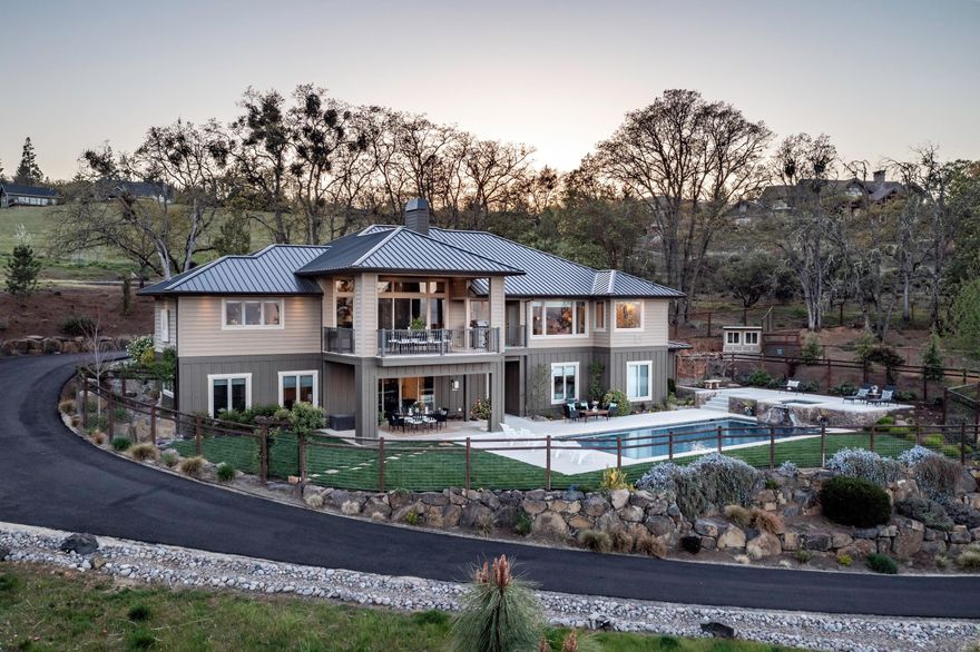 Extraordinary quality custom home with panoramic views of the Rogue Valley & mountain range. Incredible landscape design welcomes you to a well thought-out & spacious home featuring 5 bds & 4.5 baths. Located on 2.75 acres in a desirable neighborhood of exceptional homes! Main living areas & primary suite on main floor, 2 additional bedrooms are en-suite. Gourmet Chef's kitchen featuring marble countertops & granite kitchen island. Built-in Sub Zero fridge, 6 burner Wolf gas stove w/grill & double ovens plus double wall oven. 10-12ft ceilings throughout. Wide plank Brazilian walnut flooring, 2 gas & 1 wood burning fireplace. Master suite features marble tile floors, jetted tub w view window, oversized walk-in closet. Wet bar & Climate controlled wine cellar. Smart Home Tech Lutron system. Heated saltwater pool w Baja ledge & spa. Metal roof, 3 car garage, RV parking & room for a shop. Garden areas & shed. Walking distance to the charming town of Jacksonville & access to Britt trails.