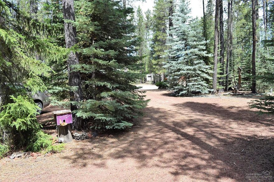This magical property has been a family summer retreat for 30 years. Set up with 2 travel trailers, decks, shower house, additional RV parking (no hook up). Property provides great privacy from the multiple Fir and Spruce trees that have grown to add to the relaxing atmosphere of this property. Property is clear of underbrush and is ready for you to start creating your Central Oregon memories