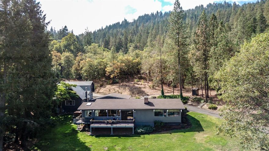 Welcome to your forever home! With acres and acres of BLM on one side - this 40 acre gem has so much to offer. Enjoy sweeping views of the beautiful Applegate Valley from the expansive deck,miles of ATV and hiking trails along year round creeks, gold mine and much more right out your front or back door. Plenty of room to garden.Perhaps a vineyard, orchard? Event venue, VRBO, Bed and Breakfast? The possibilities are endless. The home 3bd,2ba. sits on a knoll overlooking the valley. 12 gpm well,new paint and newer roof. The floors have been stripped and refinished and both bathrooms have been updated.There is no limit to the imagination when it comes to this property. The ADU is a 1bd/1 bath w/a loft apt,a perfect MIL cottage.The property boasts a large three bay shop with room for your RV and plenty of parking for hosting get togethers. Less than 20 min from Grants Pass this property is one to see.