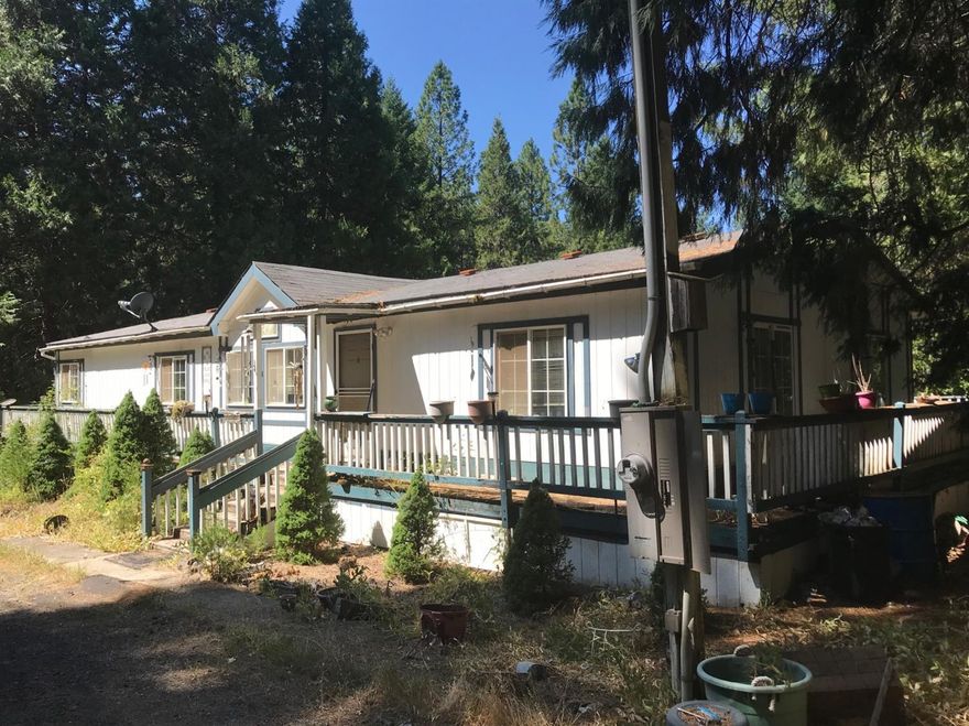 What??!! 9.86 acres with artisan well!! With a small year-round creek behind the home. Big metal shop approx 30'x 60' with concrete floor and propane generator. Also there are 3 storage sheds and a metal storage container. Power and septic on property. Property is partially fenced. There is a 1994 double wide that has been vacant for 2 years. It is in need of a new roof and interior flooring. Buyer to do their own due diligence. Property has a lot of potential with the shop and artisan well.