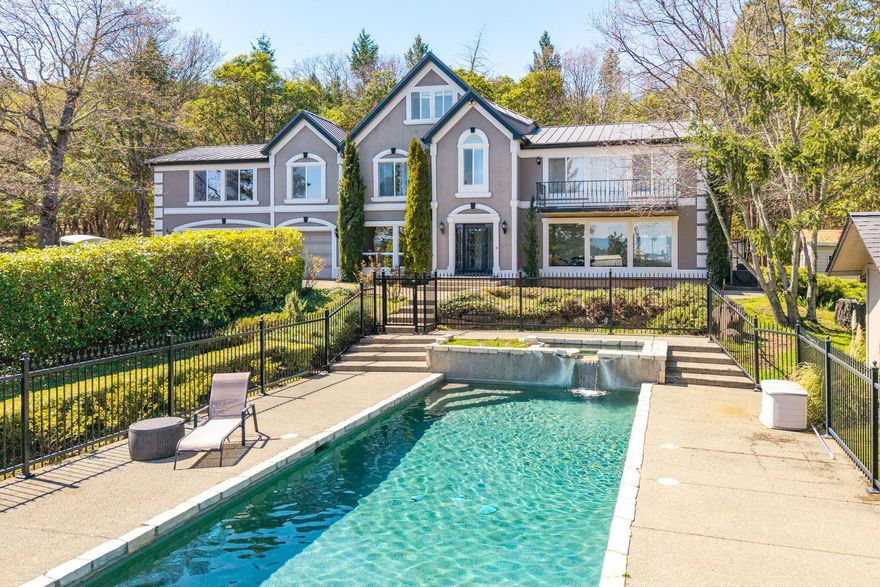 Experience the best of Southern Oregon living on this 18.84-acre estate just minutes from historic Jacksonville and the Applegate Wine Trail. The 4,099 sq.ft. home offers a 3,399 sq.ft. main residence plus a 700 sq.ft. ADU w/private entrance, perfect for guests or multi-gen living. Interior features include oak hardwood floors, granite live-edge counters, high-end appliances, custom cabinetry, vaulted ceilings, and a primary suite w/walk-in closet, jetted tub & balcony showcasing Mt. McLoughlin views. Horse enthusiasts will love the 60'x120' covered arena, 36'x48' two-story barn w/4 stalls, tack room, hay loft w/conveyor, power & water, and fenced pasture. Relax in the fenced backyard or in your own in-ground pool & spa, enjoy the gated paved drive, and savor the peace of Woodland Resource zoning while being only 15 minutes to Medford shopping, dining & medical. A rare retreat blending luxury, equestrian excellence & the beauty of Southern Oregon!