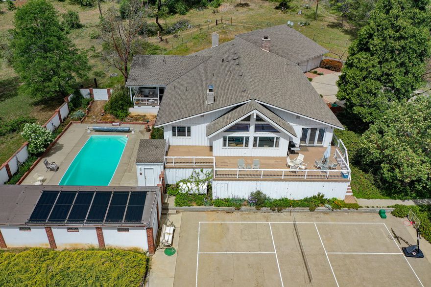 Custom built light and bright 3726 sqft home sitting on beautiful 42.19 acres w/3 tax lots! Zoning is  RR-5, EFR, WR, one tax lot backs to Wards Creek subdivision, another lot backs to BLM land. Great for horses, farming and peace & quiet. Major kitchen remodel recently & new floors through most of the home. Gated entry over Wards Creek to 3726 sq ft Ranch style home w/newer roof & newer exterior paint. This gorgeous ranch home has 3 large bedrooms + office area, 3 full bathrooms, lg vaulted open beam ceilings in Family rm & Living rm w/Lg floor to ceiling windows overlooking Mt Views & countryside. Primary bedroom has a sitting area & brick fireplace, Cedar built-ins, lg walk in closet, dbl sink & vanity w/ tile & tile floors & shower, separate soaking tub, water closet.  Heated in ground pool & 3rd covered patio. 2 car attached garage plus detached 6 car shop & 3 car garage approx. 36 x 47 2 story barn, approx 200 X 110 shop, white railing arena. Bring your animals or a green thumb!