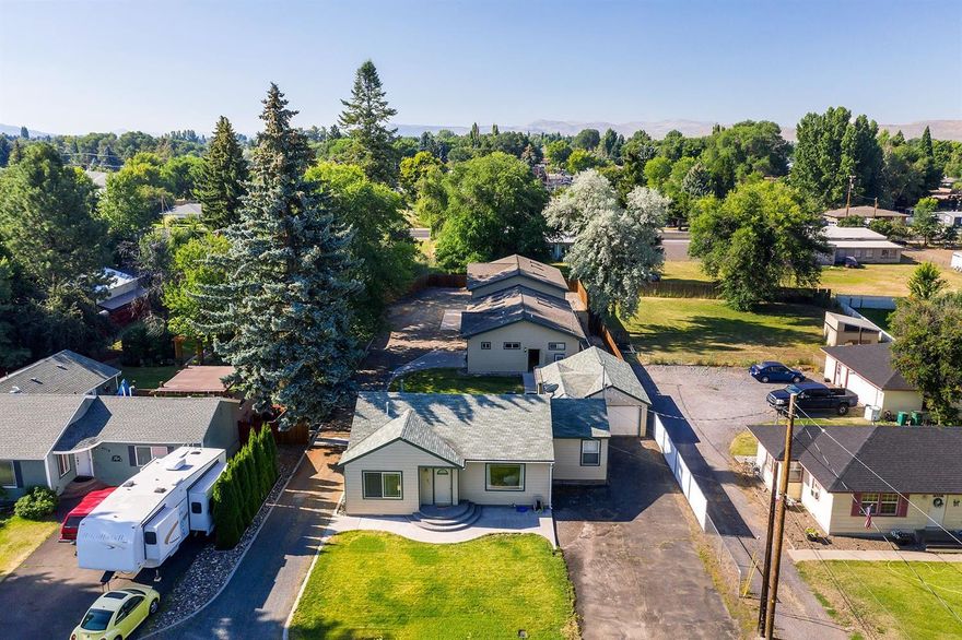 This home is a real sleeper. Vaulted ceiling, hardwood Maple floor, Tile in office & bathroom. Home has been wired for surround sound. Skylight & sunshade. Large back deck. Cute & cozy from the street hidden behind home 30'x80' shop with 200 amp service, 12 roll up doors. Floor in shop has radiant heat, 110/220 power. Plus cave with 1/2 bath. And additional gas heat