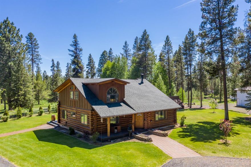 Charming hand-scribed log home on private 5.48 acres, fully fenced and gated w/ horse facilities & large RV barn, just minutes from Sunriver! Enjoy the vaulted great room and slate floor entry, this 3 BR, 2 BA + loft lives large. Kitchen boasts slab granite counters & breakfast bar, vaulted master with jetted tub & marble shower. Spacious deck with hot tub for enjoying the clear night Central Oregon sky! Additional buildings include nice horse barn with 2 corrals, 2 horse stalls & separate, fenced pastures, 768 sq ft RV storage with 14 ft door and full hookups & large, log shed. Nicely landscaped, well manicured property with peek-a-boo mountain views. See virtual media tour for full scope of the property. Don't miss this one!!