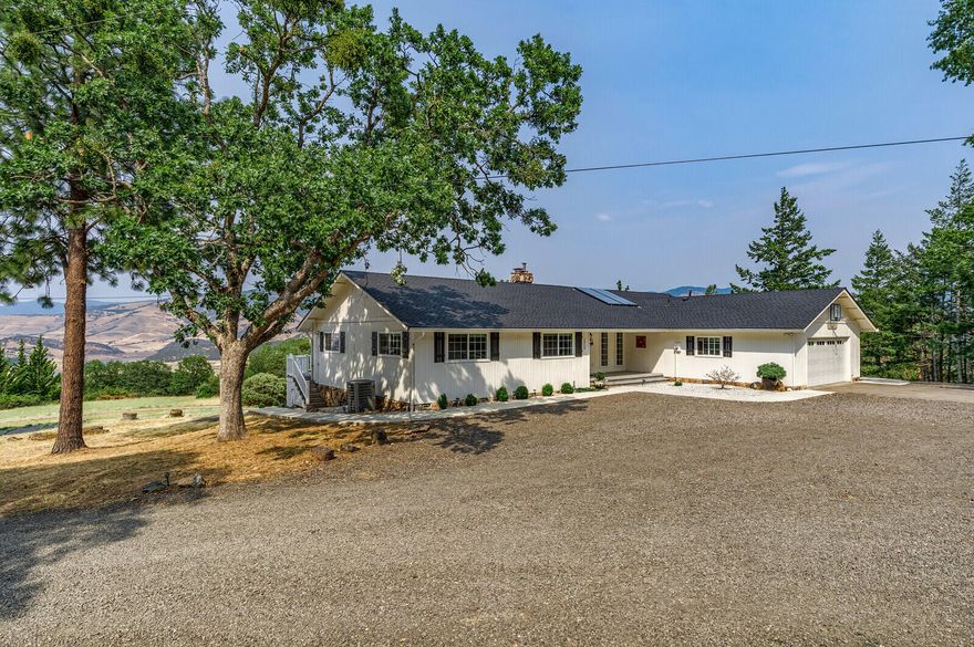 Private rural home with panoramic views of Emigrant Lake and the Cascade mountains including Grizzly Peak! 15 minutes from downtown Ashland. Surrounded by evergreens and Madrone trees, featuring a beautiful modern country updated home plus an additional guest cottage! The main home is 3790 sq ft and includes 3 bedrooms & 3.5 baths. Upstairs is a spacious screened in porch and a beautiful updated kitchen. Open concept dining and living room includes a wood stove and vaulted ceilings. Views of the mountains and lake through every window. Tons of natural light. Outside you will enjoy an expansive deck with hot tub located outside the primary bedroom. The lower level is ready for entertainment plus a full bath & access to the patio area. Newly built craftsman cottage is 900 sq ft, 2 bedroom+ den, and 1.5 bath. On its' own 2 acre tax lot with its own septic. Shared 18 gpm well and detached garage!