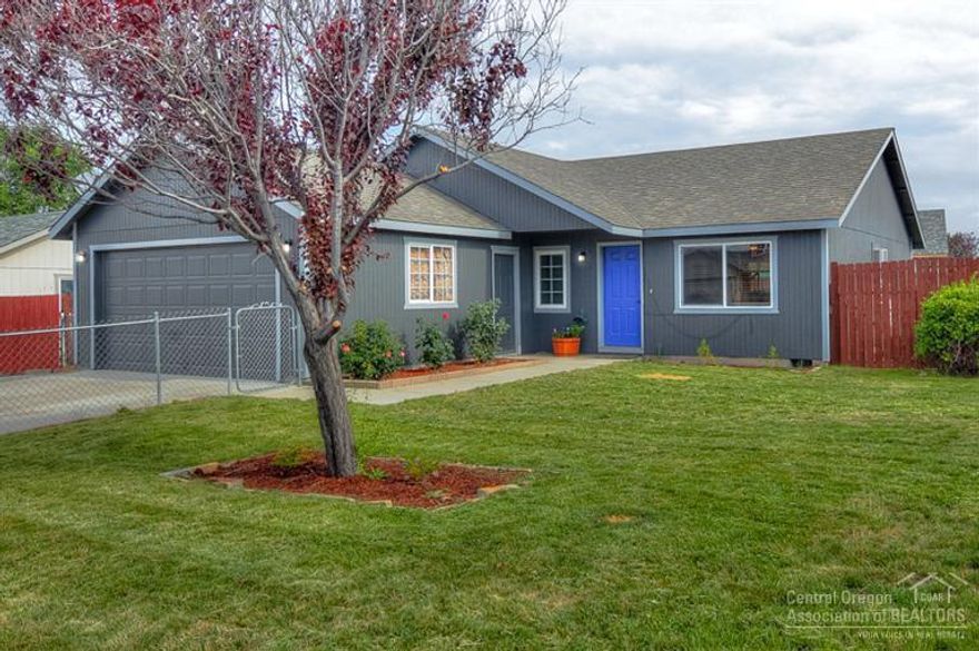 Ideal location in NW Redmond! Just blocks from Quince Park & schools. Easy access to HWY97. All new exterior paint! Fence also freshly painted! Open living space, newly installed wood laminate flooring. Tiled kitchen counters w/bar. Bedrooms & trim are freshly painted. French doors open to lrg covered back patio.Lrg corner lot, fully fenced with RV parking. Sprinkler system