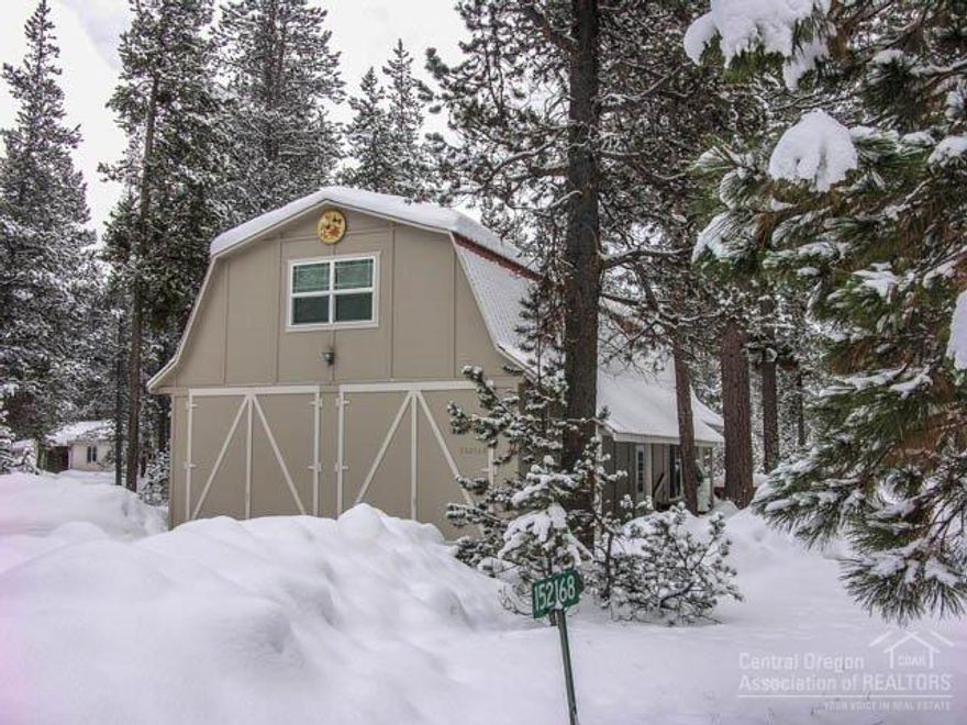 Unique Barn-Style Home in the Big Pines on 1+ Acres Close To River! 4Bd/2.5Ba NW style home w/great room, knotty-pine accents, HW floors, wd stv, open dining/kitchen, main level master w/bath & slider to back deck & Hot Tub + 2nd master upstairs + family room, 2 more beds, half-bath, laundry, deep 2+ car garage, wrap around deck w/great forest views & water feature all on large corner lot! Owner/Community Pool, clubhouse, maintained roads & 3-easy owner access points to the River for fishing & kayaking!