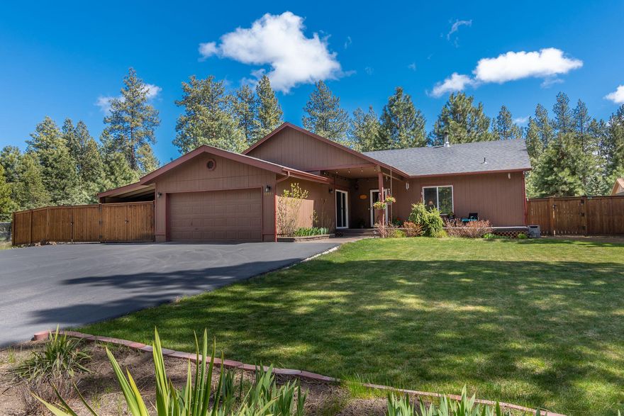 Enjoy the surroundings of this well-maintained single level home in Deschutes River Woods! Just under an acre with mature pines that line the front of the property including a paved driveway. This home has 3 bedrooms with an extra flex-room/office-space. Main bedroom separation with French doors that lead out to the back deck. An open floor plan that makes you feel at home with a woodstove for those winter months and a new heat pump providing A/C in the summer months! Prewired for surround sound. Attached to the garage is an enclosed breezeway used as a workshop and a gated carport for extra storage or parking. Hot tub included! RV parking with 240V hookup. Over $50,000 in improvements to the property! Fully fenced backyard and front privacy fence. Trex decking, patio w/ pavers, new heat pump, extra graveled northside drive, Additional entry gates. Landscaped front walkway w/ covered front porch.  Easy access to the Old Mill, Mt. Bachelor and all the Bend has to offer! Tour it today!