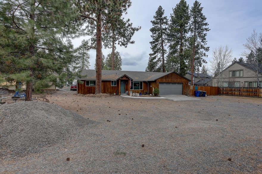 Short term rental permit approved for existing home, Tentative proposal approved for 6 SFR homes, approved plans and permit to expand existing home by nearly 25% and have a Bend City approved ADU, plus RV pad with power. The existing 1400 sqft home has a fresh remodel which includes new cabinets (not refinished, new) and upgraded appliances fully updated bathrooms, new carpet in the bedrooms, new furnace and air conditioner. Water and sewer have been tied in to the city in 2022. Collect significant rent from both the existing home and the RV space that has 50 amp service,50 gallon propane, and clean-out, and it still gets better; the city has approved a carve out for a tiny home that can be split off the SE corner of property on completion of the subdivision. Seller has put much towards building out the 6 SFR's and is moving forward. Price based on where the project stands today. Tractors can be moving dirt this summer. Agent is related to Seller and has share.