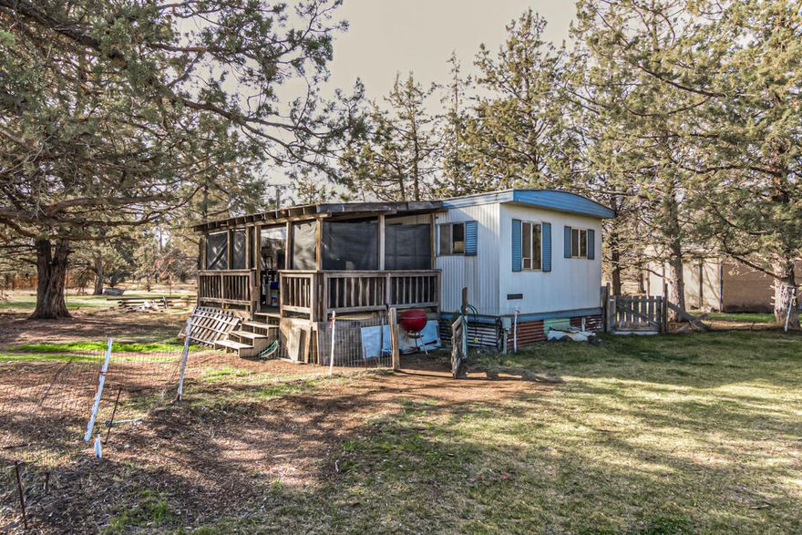 This flat and private 2.31 acre corner property offers a chance to build a new or refresh the manufactured home currently located there. It is close to the paved road while not far from the entrance to Crooked River Ranch. The smaller 2/bed, 1/bth home means less upkeep, while the property can satisfy nearly anyone's ambitious vision. a couple of smaller sheds will help store odds and ends, while the carport offers covered parking or storage. The at one time horse-occupied property still has a three-sided eaved structure, which was previously used as a loafing shed, where a future pasture could again be realized. driveway adjacent is a mostly cleared square of property, that is eager to have animals frolicking in the field. Come and see what opportunity awaits!