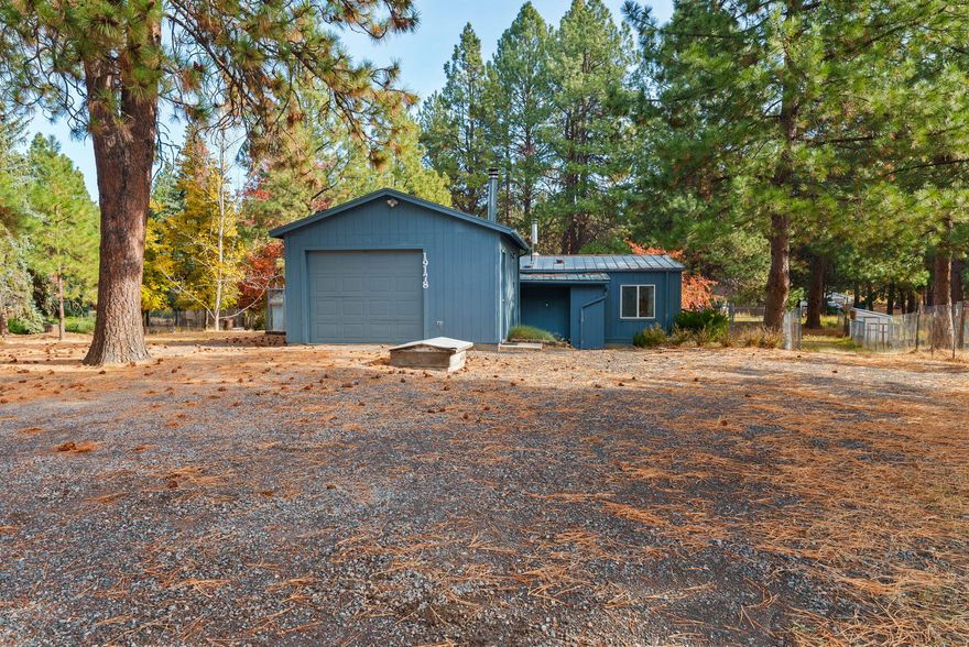 Affordable Central Oregon living with room to breathe! This 2-bedroom, 1-bath double-wide manufactured home sits on a spacious 0.54-acre lot in Deschutes River Woods, backing to a peaceful canal and surrounded by mature trees for added privacy. 

Enjoy a fully fenced backyard, two storage sheds, a 144 sq ft pump house, and an enclosed entry—providing plenty of space for storage, projects, and hobbies.

Offering 864 sq ft of living space plus a 352 sq ft single-car garage (built in 1995), this property blends function and potential. Shared well and county records suggest updated septic system (county records show expired permit record so buyer to do further due diligence and inspections).

Built prior to June 15, 1976, this home qualifies for cash or non-conventional financing only. A fantastic opportunity to own property in Bend for under $250K, just minutes from town, the river, and outdoor recreation!

Twice moved and built prior to June 15th, 1976 so loans are limited