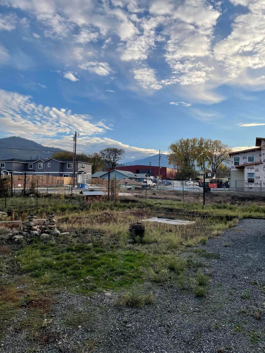Looking to build your dream home in Talent? Power, water and sewer are all present on this level lot.  You'll love the mountain views, and how close the shopping and schools are.  Per city, new owner can live in RV while building their new home or bring a double wide mobile home on the property.