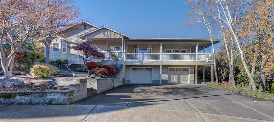 This home offers an exceptional lifestyle. It is visually appealing from the street, & throughout the home. Easy care landscaping, with automatic sprinklers. A wrap-around deck on 3 sides is accessible from the front door, the dble doors in the LR, the kitchen & the mastr brm. The Great Room has a vaulted ceiling with wood trim, & a gas log fireplace with a hearth, a mantel, & TV connections above. There are built-in cabinets, & a bay window in the LR. There are built-in, zone controlled speakers in the GR, mstr brm, & on the back deck. The Master Suite is spacious, with a bay window next to a seating area, a walk-in closet & a ceiling fan. The MB has dble sinks, a soaking tub, and a stall shower. The 3rd bedroom has a lg bay window, with a built-in bench seat & a cabinet below. The extra deep, finished garage has 2 automatic door openers, a man cave, & a shop area. A door in the garage leads to a dry storage area under the house. A Home Warranty in included.