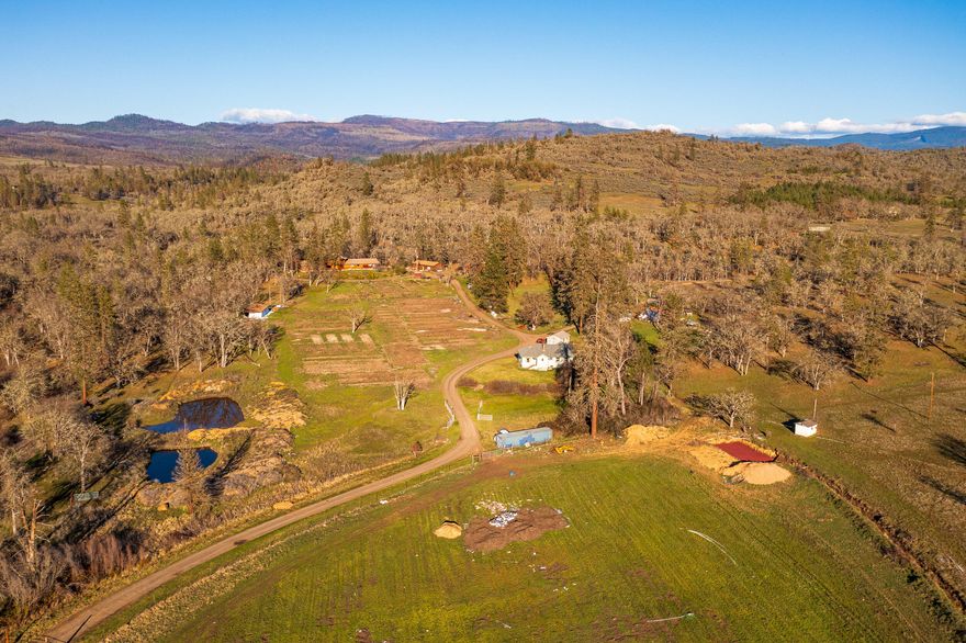 Lick Creek Ranch offers wonderful character throughout the 211 acres w/irrigated & dryland pastures, oak savannas, tree-lined meadows, creek, ponds & more. The gently rolling hills provide great vantage points w/views of the mountains & surrounding valley. 15 acres of irrigation rights with a priority date on Little Butte Creek of 1883. 3-private wells serve the homes and grounds including one well that produced over 200 GPM when drilled. This property has fantastic hunting right out your back door and numerous trails for a wide range of recreational opportunities. The main home, constructed of true dimensional logs, offers a dramatic great room w/ cathedral ceilings & a rock fireplace ready to be updated by the new owners. The second home is 1,597 square feet and was updated in the early 2000's. The property is conveniently located, with direct access off of Highway 140 & less than 7 miles from conveniences and 17 miles from the Rogue Valley International Airport.
