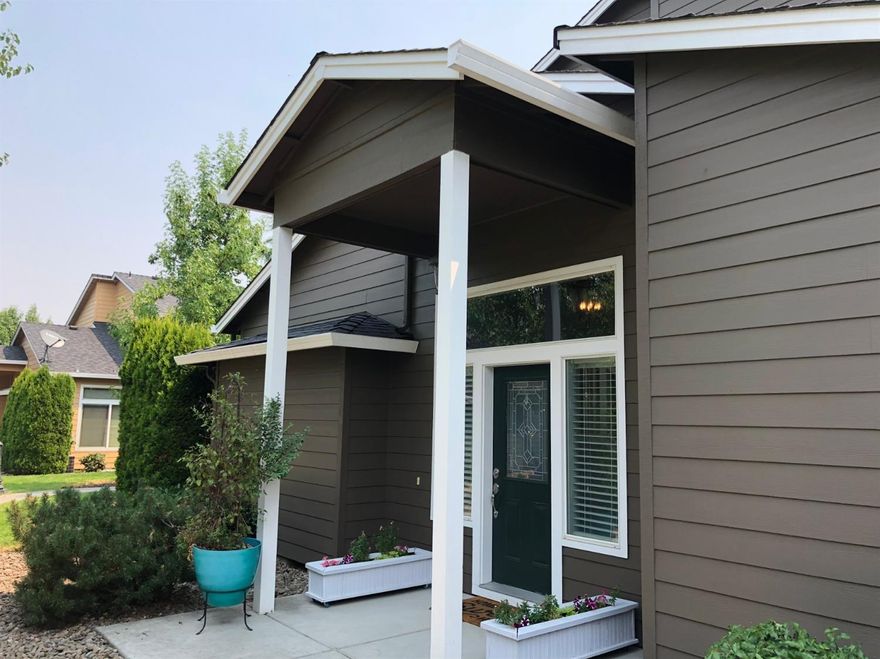 Tastefully updated Craftsman style townhome in quaint Central Point East! Beautiful wood-look laminate flooring throughout the downstairs with fresh interior paint and custom baseboards. This home features cathedral ceilings in the light and bright great room, open to the kitchen and dining room. Wonderful architectural details in this charming home. Curved archway to view dining room from kitchen. Living room with alcove for your big screen TV. Large pantry, bedroom/office and half bath downstairs. Attractive banisters with angled staircase and landing. Upstairs boasts two large Master Suites, one with walk-in closet and sitting area with new carpet throughout. Laundry is conveniently located upstairs. Perfect for a couple or a family looking for a low maintenance, move-in ready home! The HOA covers exterior maintenance and landscaping. 2 car attached garage. Walking distance to the neighborhood park. Pride of ownership is evident in this beautifully maintained home!